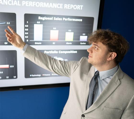 Business student pointing to accounting presentation
