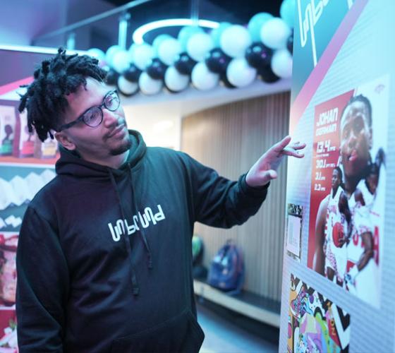 Graphic Design student explaining his projects at the graphic design show