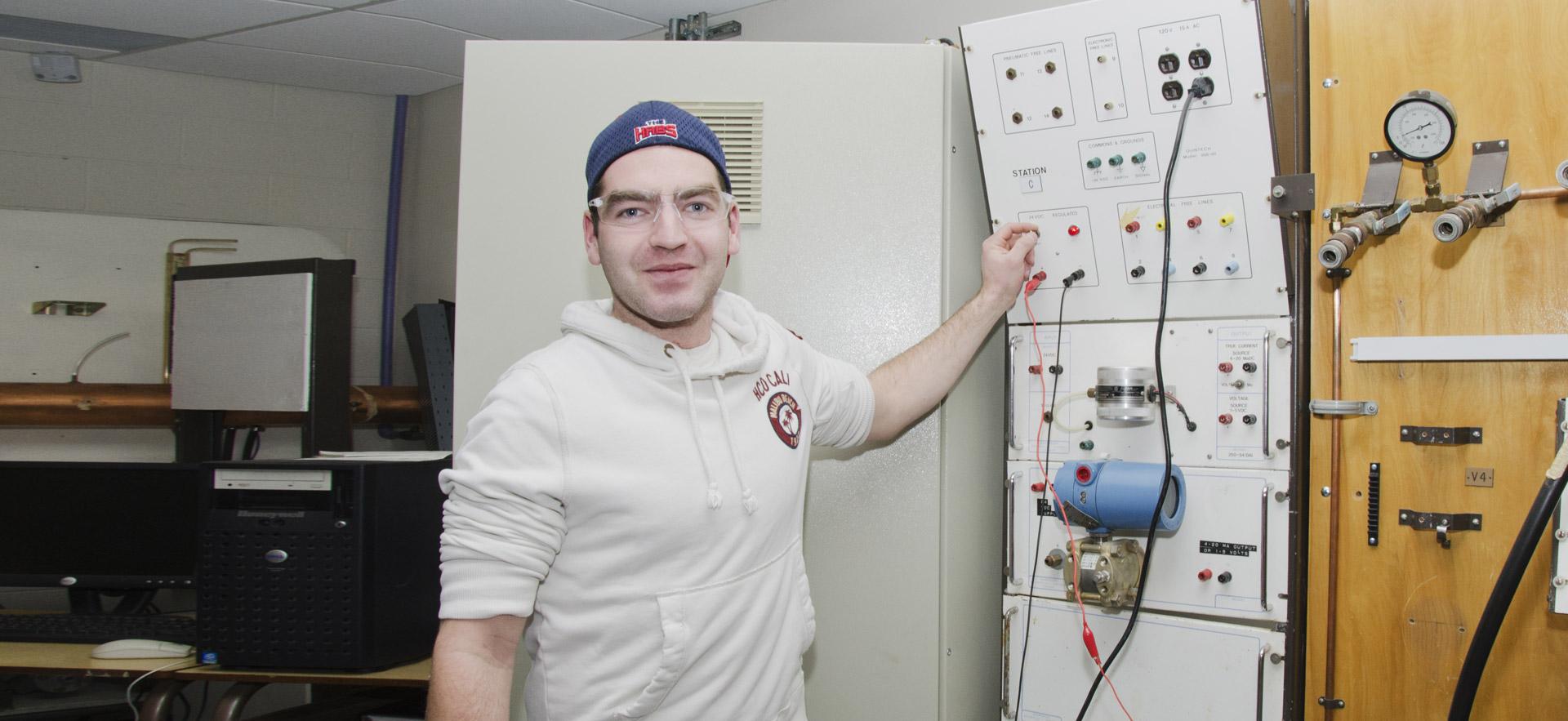 One male Industrial Electrician student works on a class assignment. 