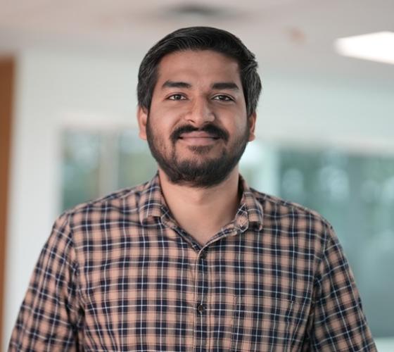 International student posed and smiling at the camera