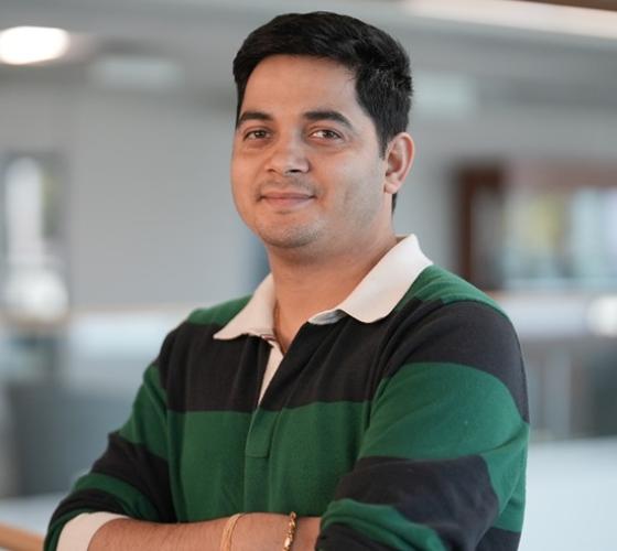 Student crossing arms and smiling at camera