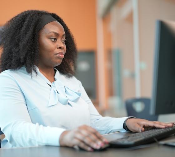Student working on computer in study hall