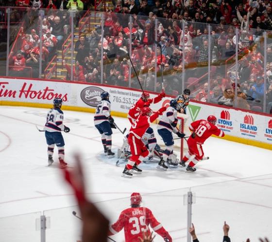 Soo Greyhounds shown on ice with opponents celebrating a goal