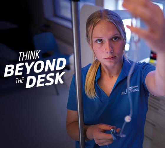 Think Beyond the Desk white text over image of nursing student looking at IV