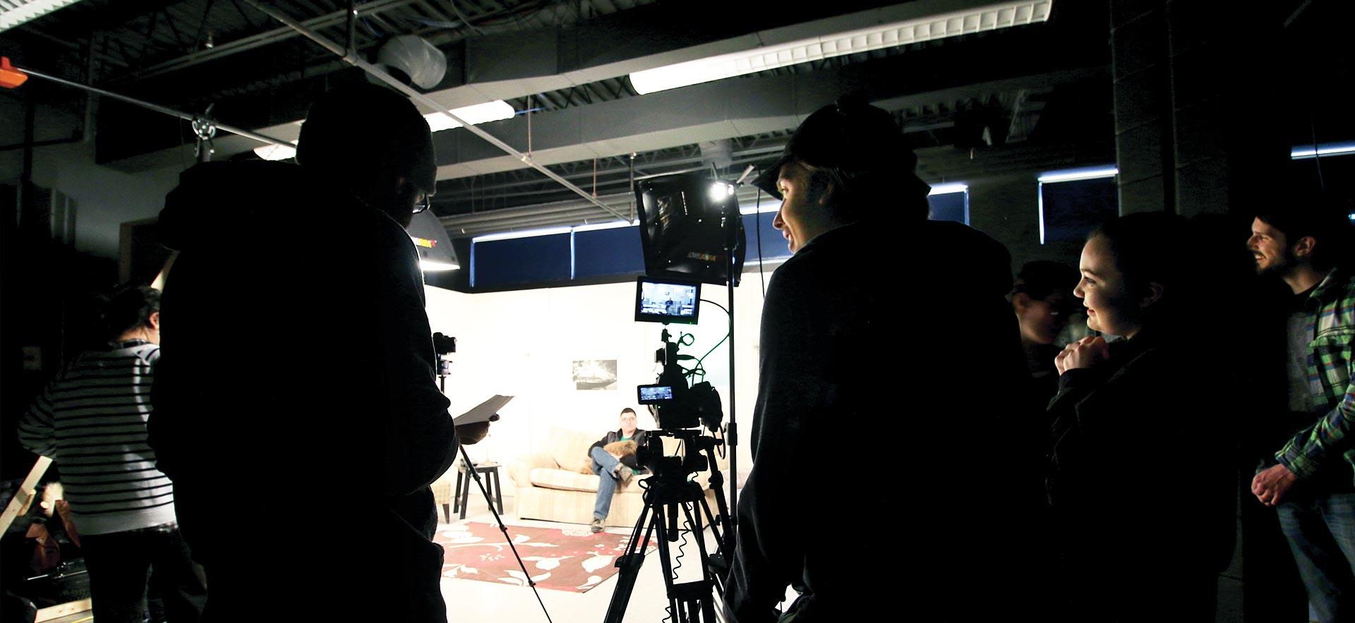 A Digital Film Production class collaborate together in a film class. 