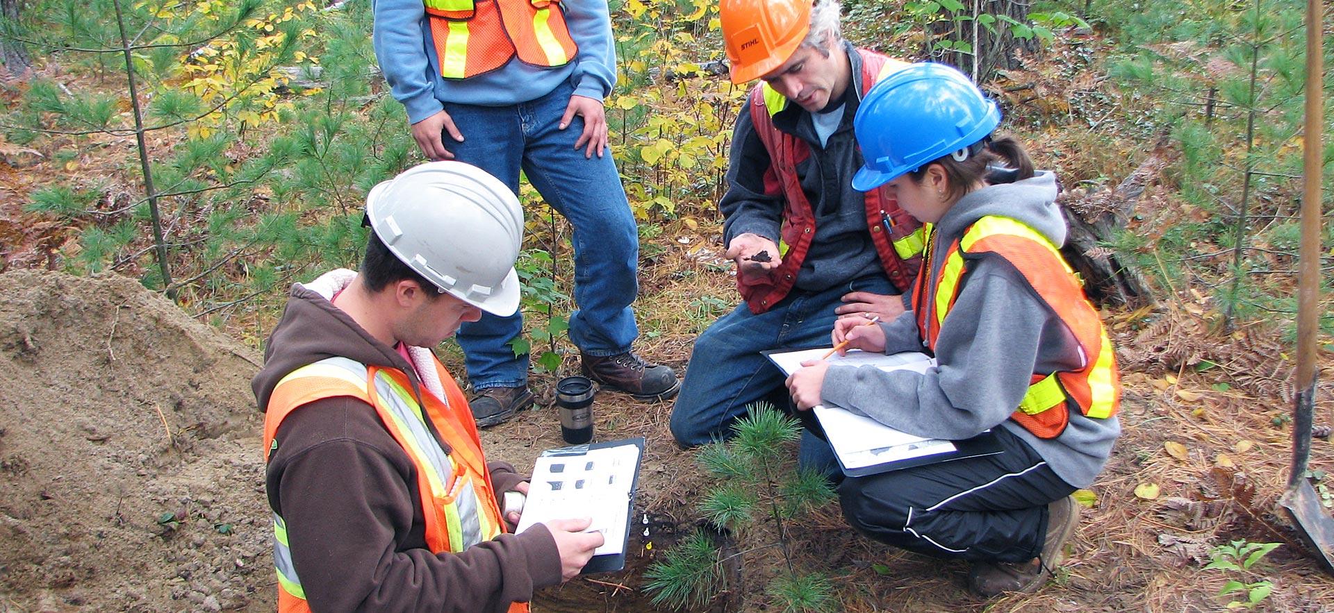 Forestry conservation technician students examine soil.
