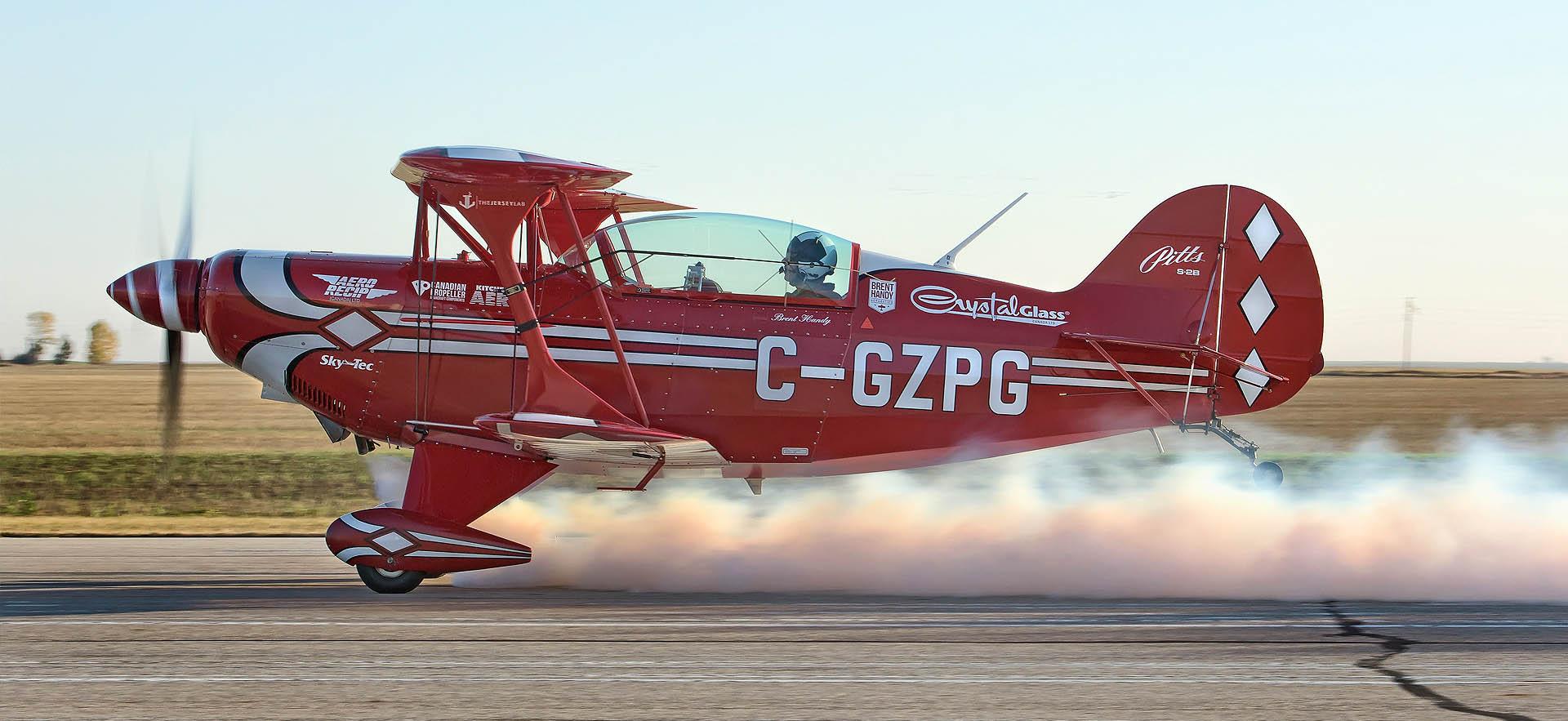 Acrobatic plane smoking on runway