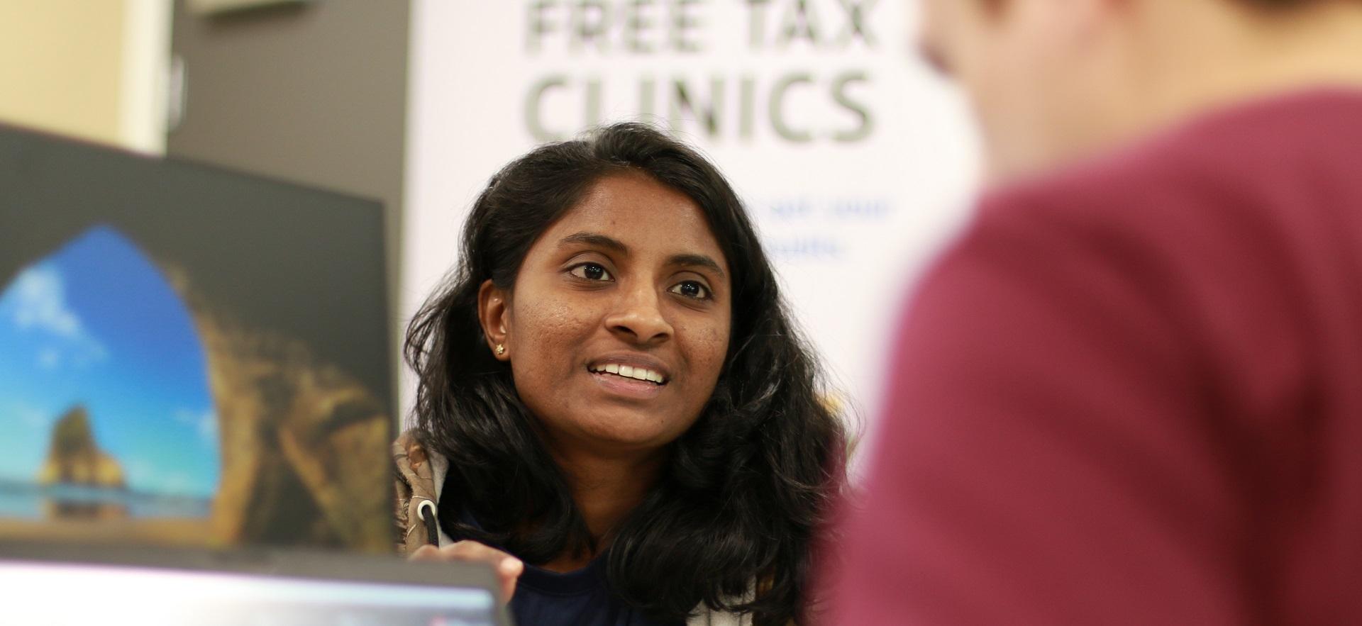 Business student helping fellow student during the free tax clinic