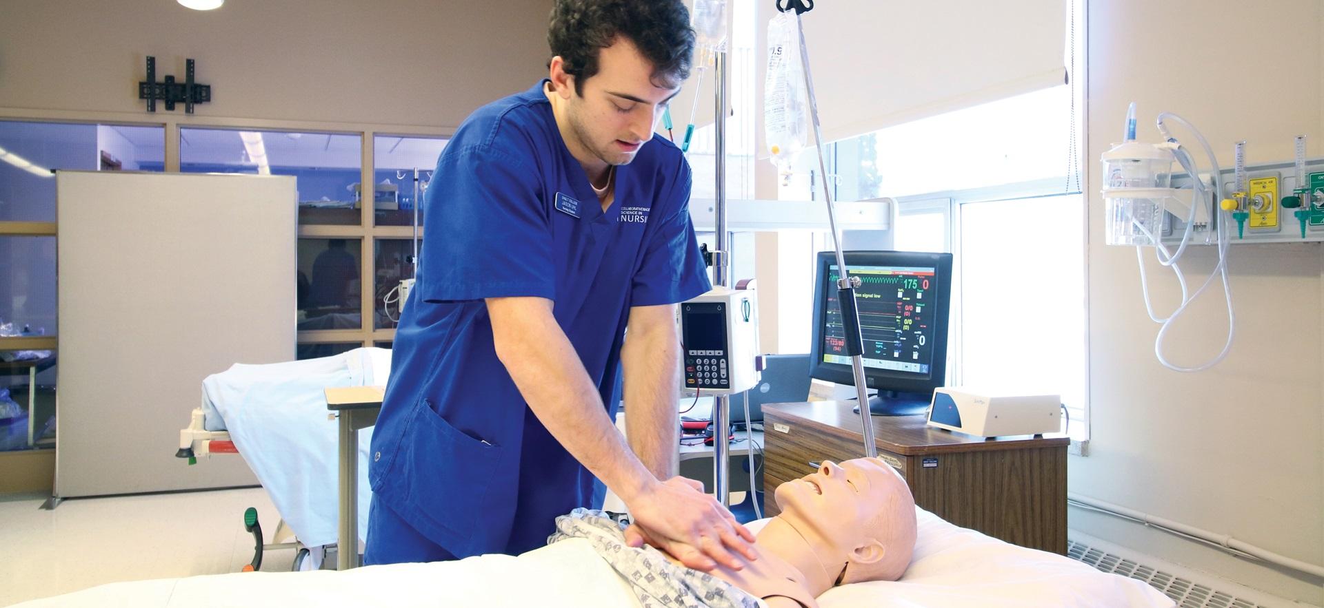 Nursing student performing chest compressions on simulation manikin