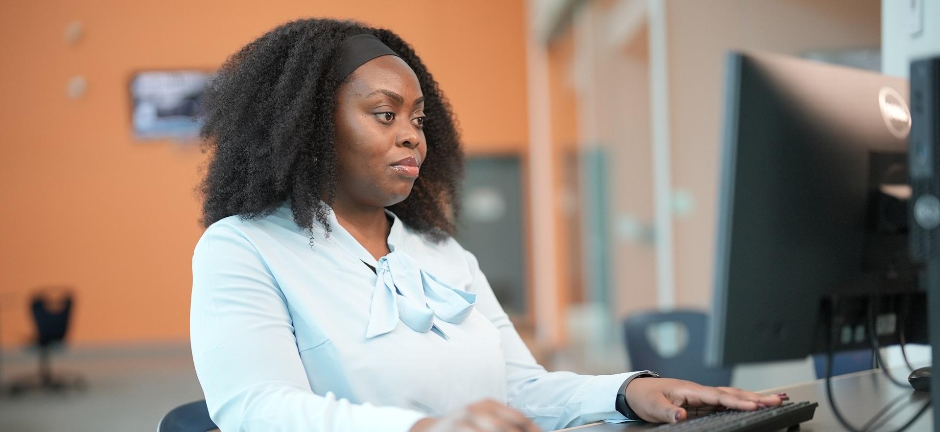 Student working on computer in study hall