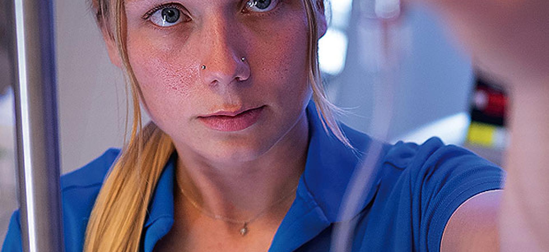 student nurse looking up at IV